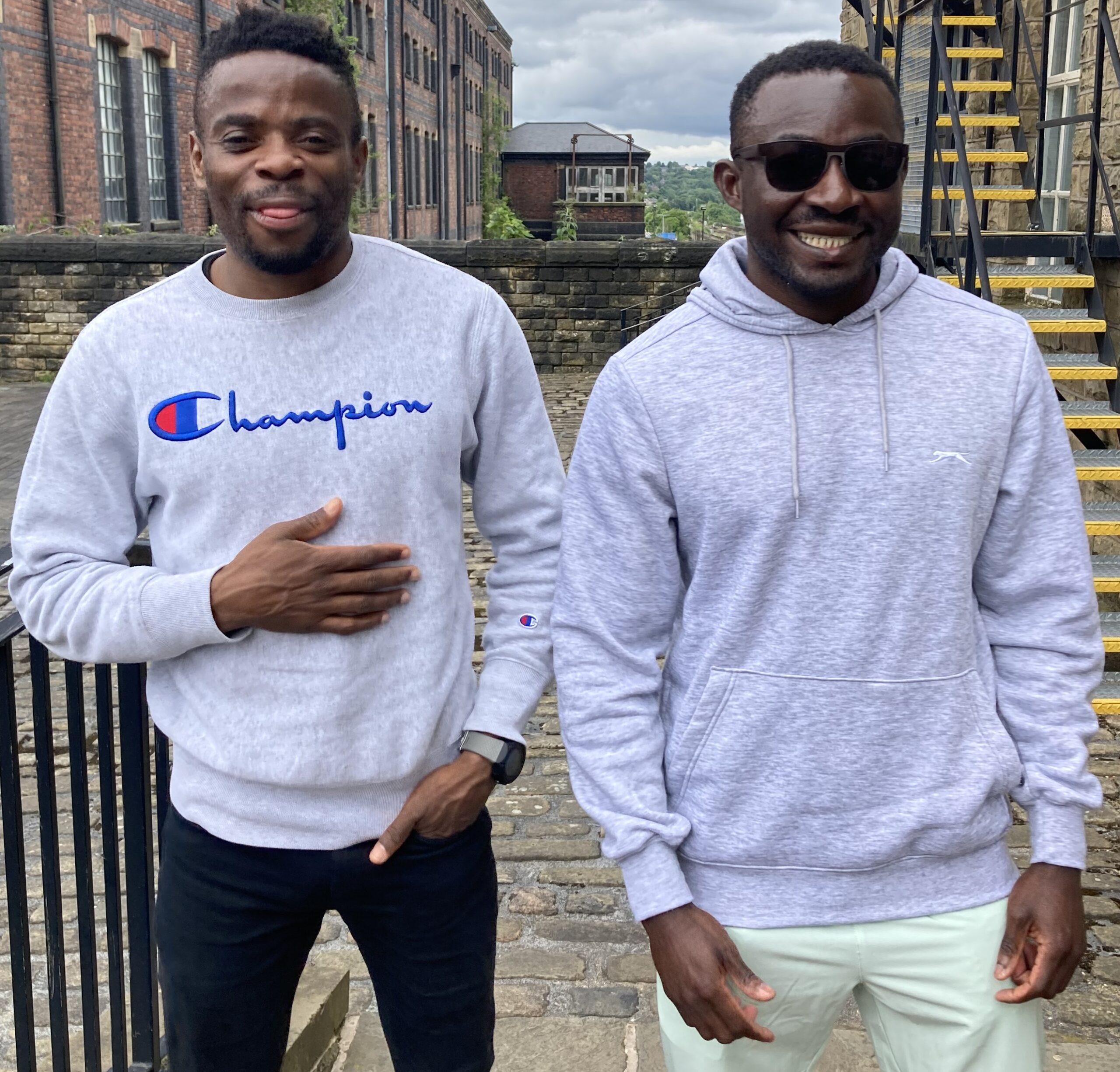 Image shows Donard and Junior standing outside Brian Jackson House smiling.